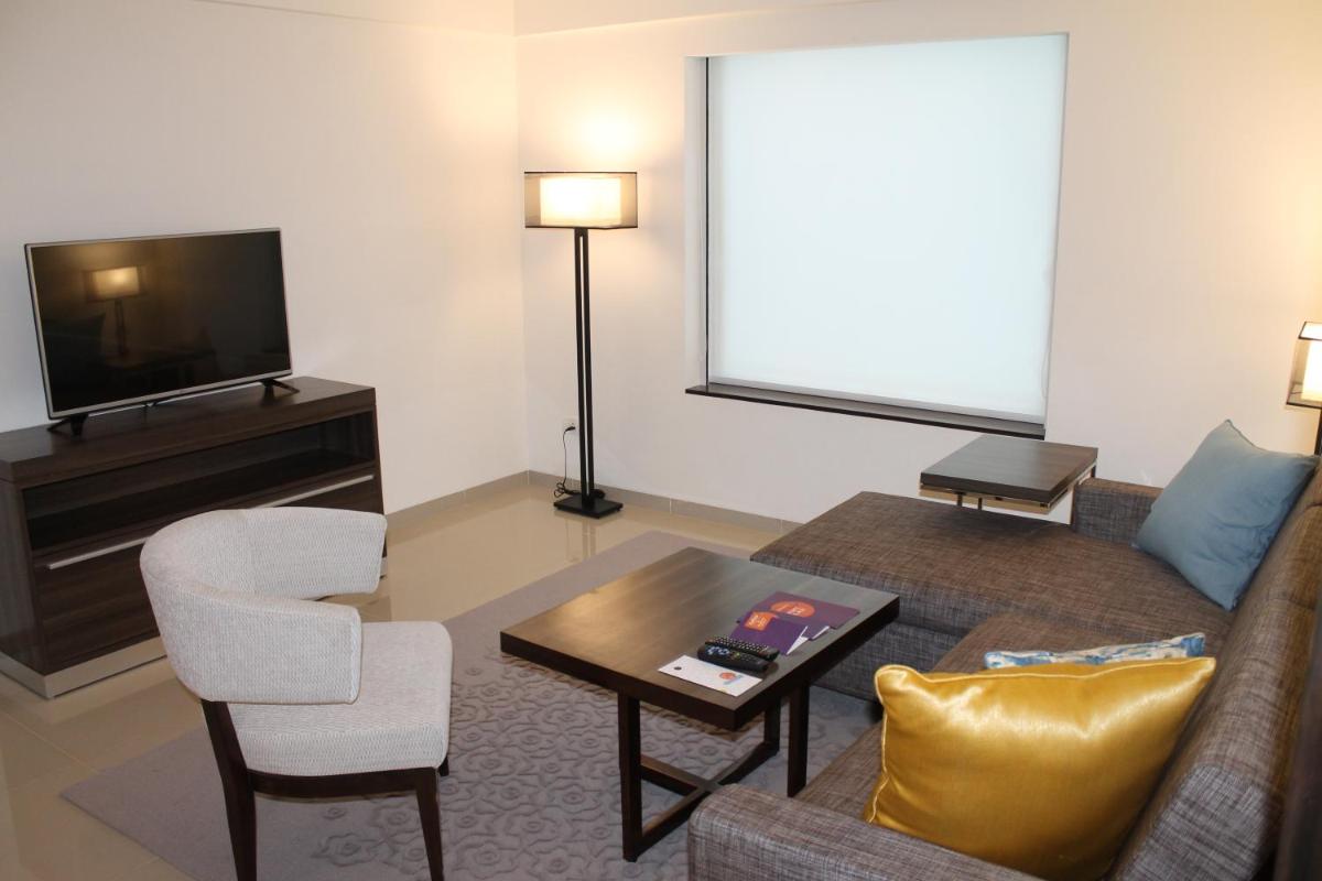 a living room with a couch and a tv at The Residency Towers, Rameswaram in Rāmeswaram