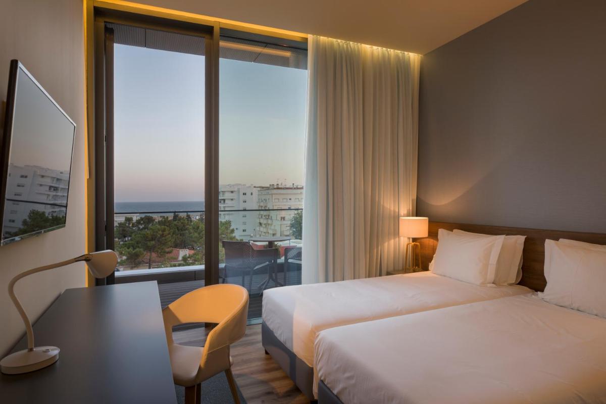 Uma cama ou camas num quarto em The Prime Energize Hotel & SPA - Algarve