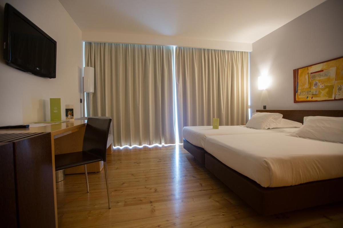 Uma cama ou camas num quarto em Monte Prado Hotel & Spa