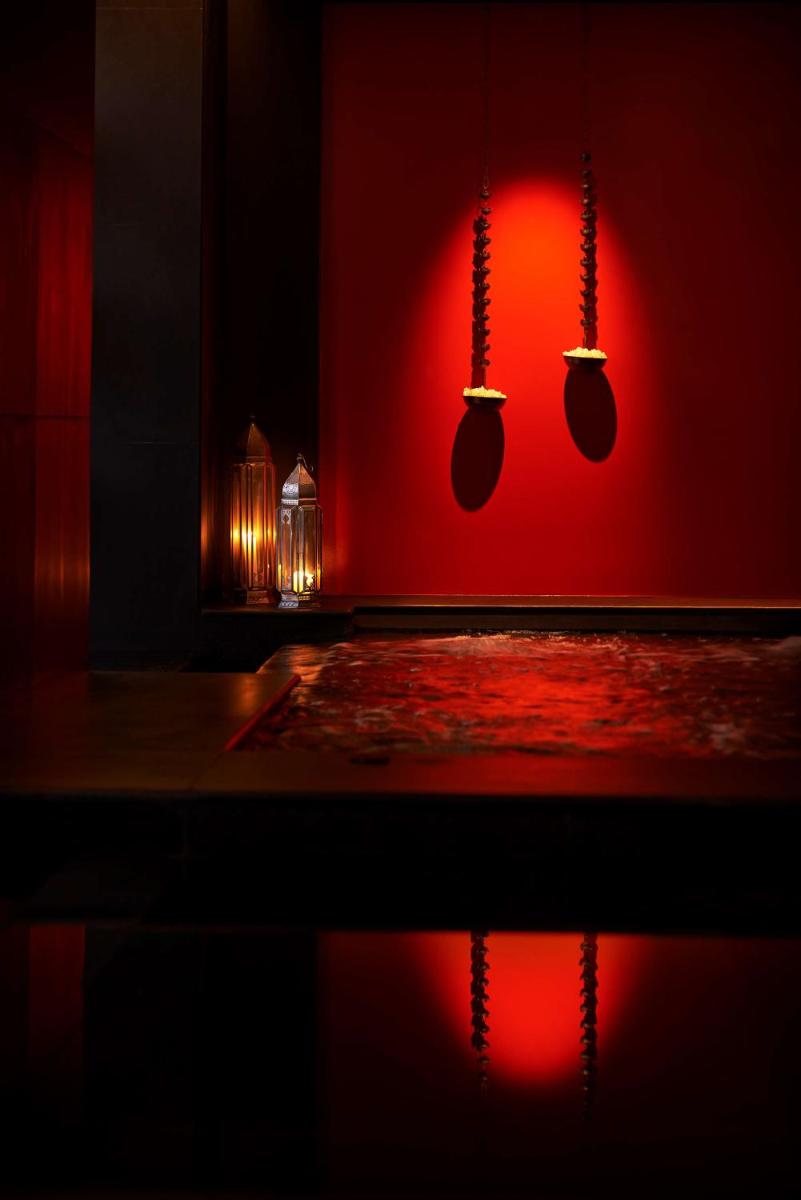 a room with a red wall with mitts on it at Park Hyatt Chennai in Chennai