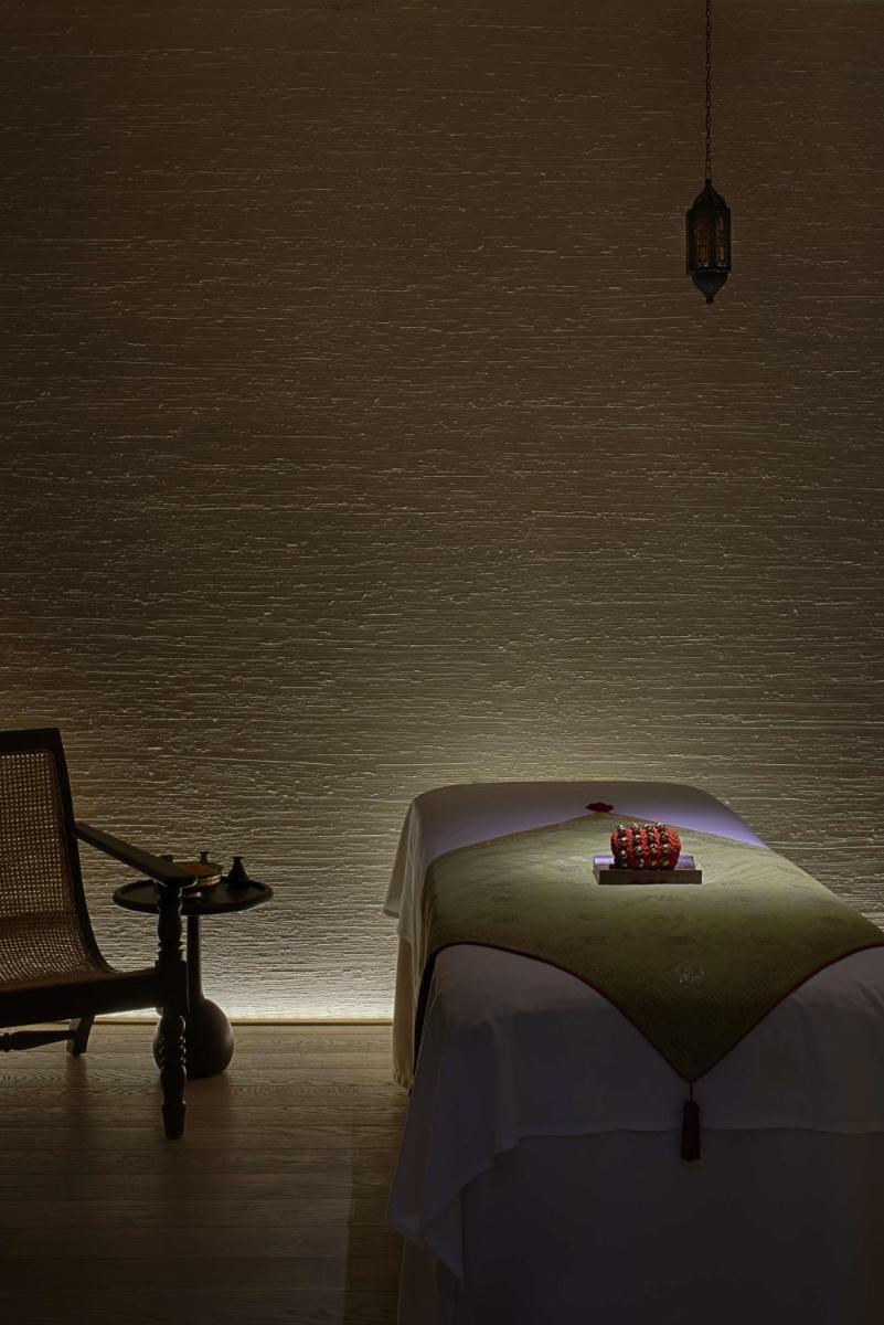 a bedroom with a bed and a chair and a table at Park Hyatt Chennai in Chennai