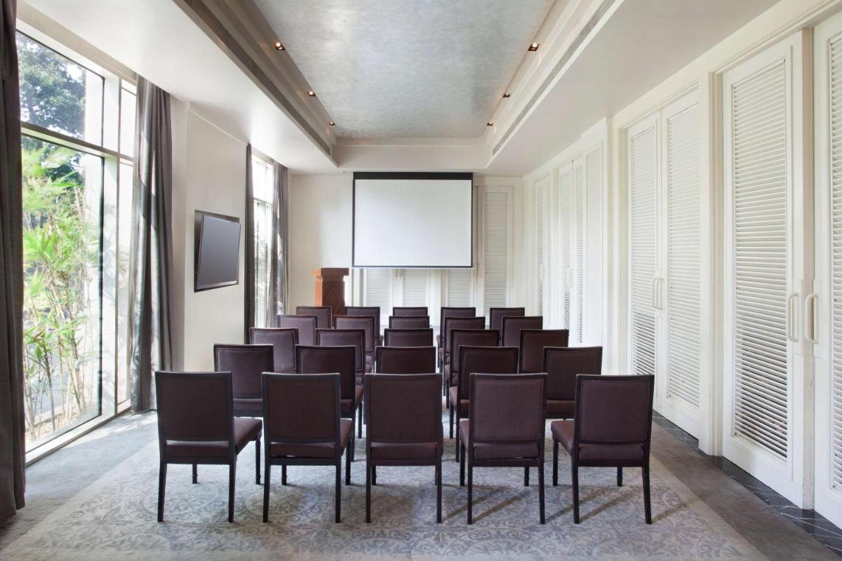 a conference room with a bunch of chairs and a screen at Park Hyatt Chennai in Chennai