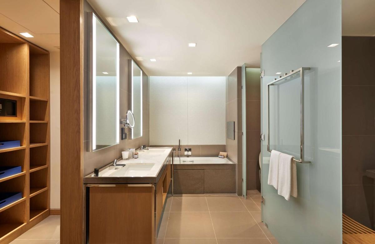 a bathroom with two sinks and a shower at Andaz Delhi, by Hyatt in New Delhi a bathroom with two sinks and a shower at Andaz Delhi, by Hyatt in New Delhi