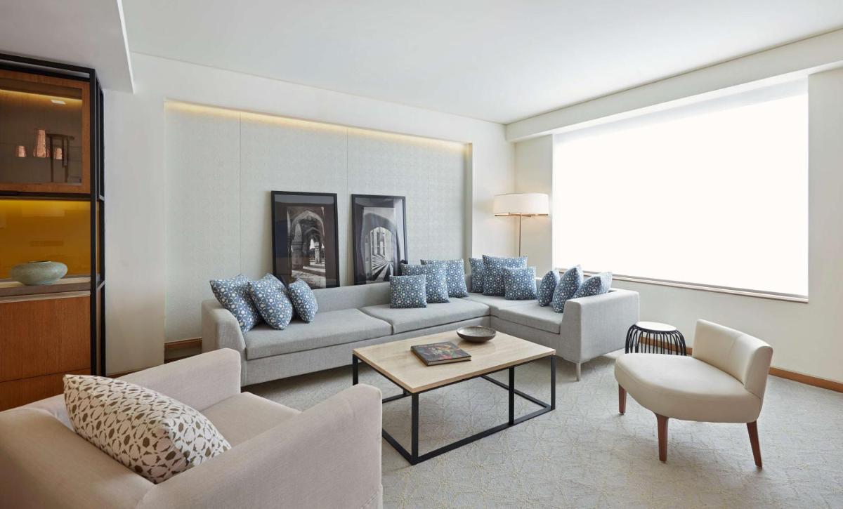a living room with two couches and a table at Andaz Delhi, by Hyatt in New Delhi a living room with two couches and a table at Andaz Delhi, by Hyatt in New Delhi