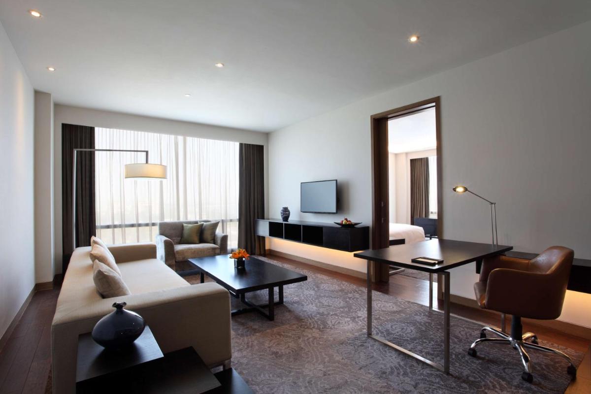 a living room with a couch and a table at Hyatt Regency Ahmedabad in Ahmedabad