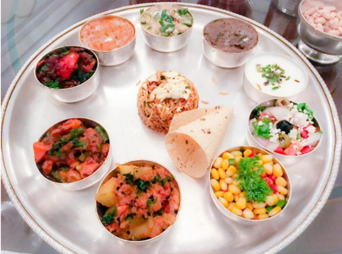 a plate of food with different types of food at The Raj Palace (Small Luxury Hotels of the World) in Jaipur