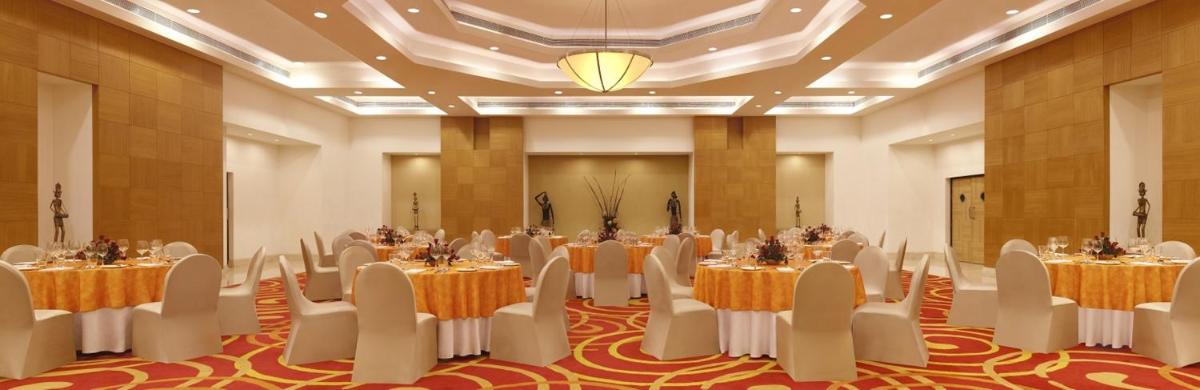 a banquet hall with tables and chairs in a room at Lemon Tree Premier Hitec City Hyderabad in Hyderabad +43 photos