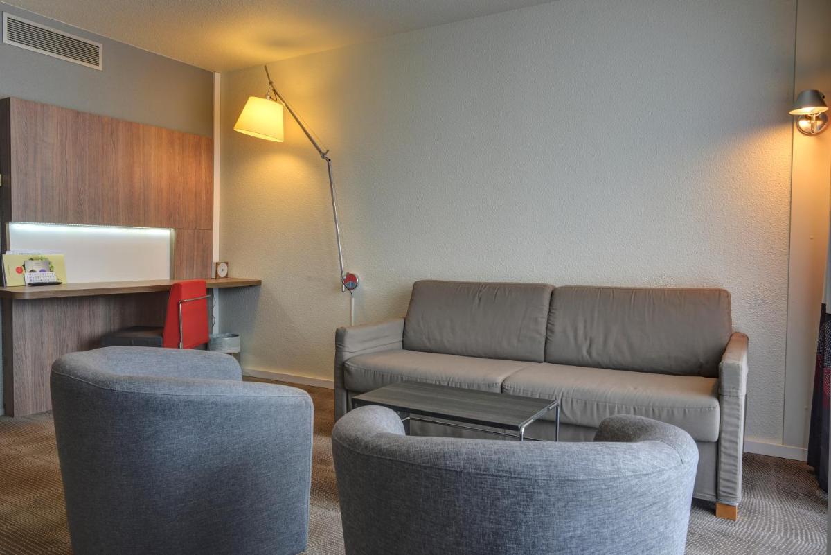 Coin salon dans l'établissement Novotel Senart Golf De Greenparc