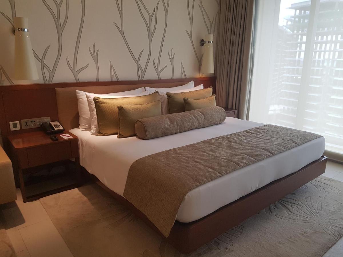 a bedroom with a large bed with pillows at Taj Yeshwantpur Bengaluru in Bengaluru a bedroom with a large bed with pillows at Taj Yeshwantpur Bengaluru in Bengaluru