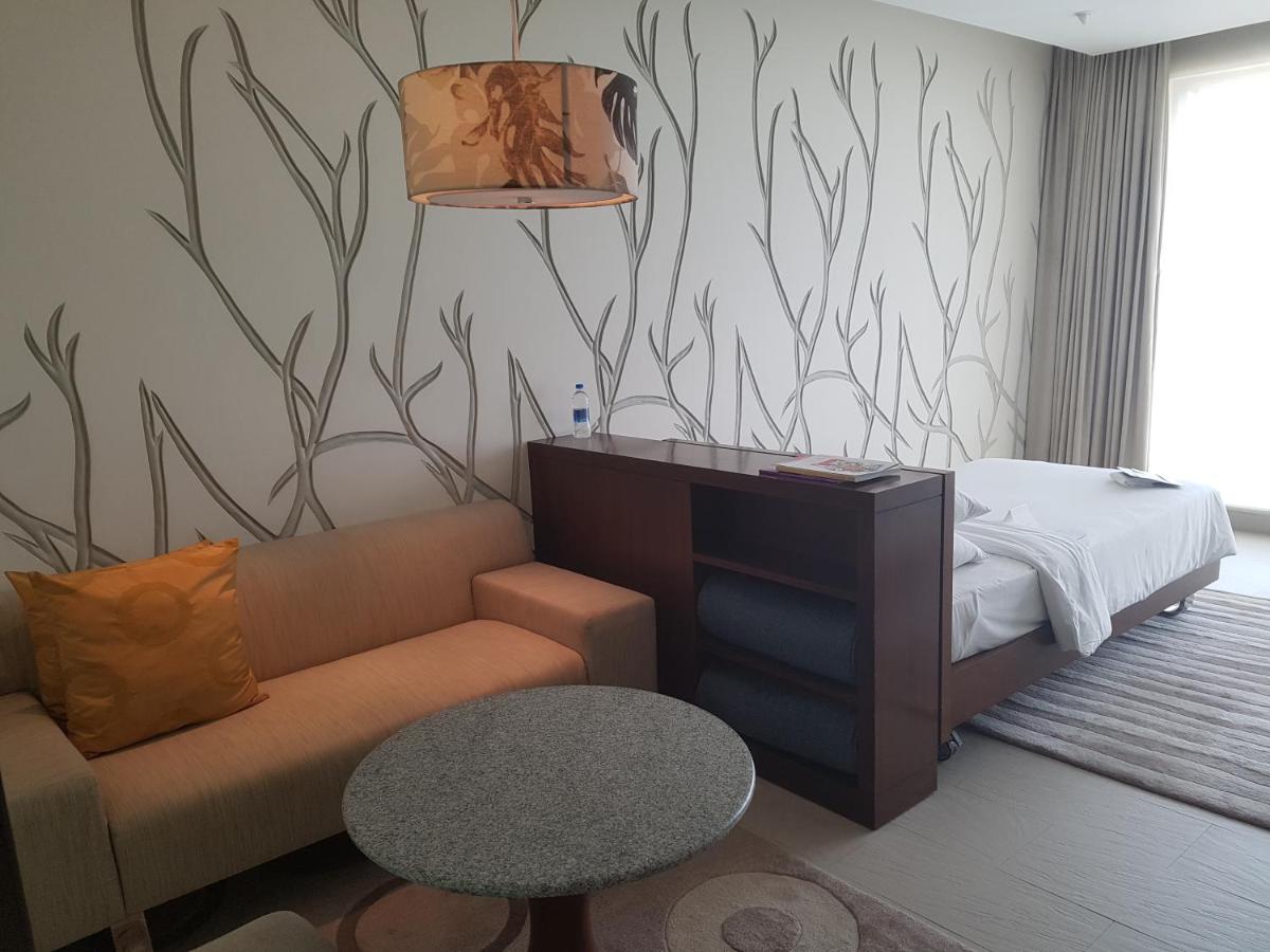 a living room with a couch and a table at Taj Yeshwantpur Bengaluru in Bengaluru a living room with a couch and a table at Taj Yeshwantpur Bengaluru in Bengaluru