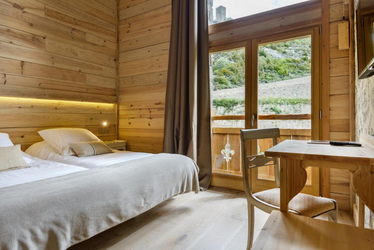 Cama o camas de una habitación en Hotel Viñas de Lárrede