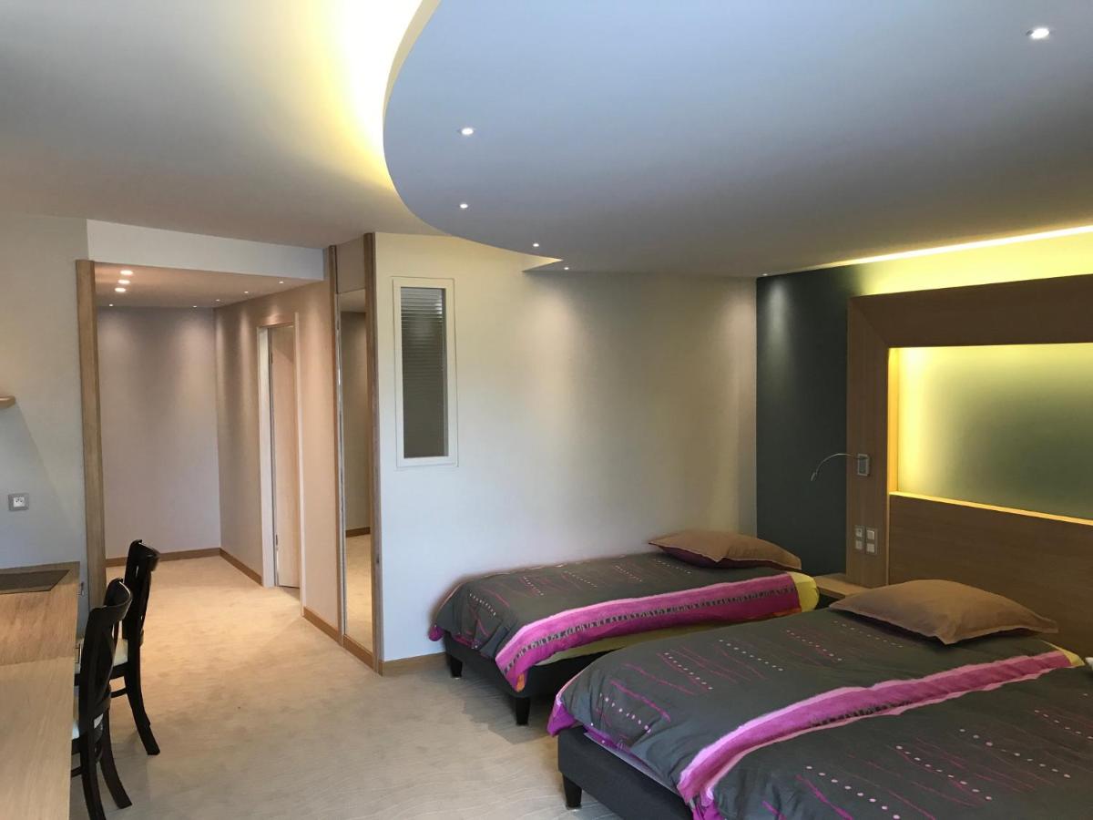 Un ou plusieurs lits dans un hébergement de l'établissement Au Soleil, Hôtel Restaurant & Spa