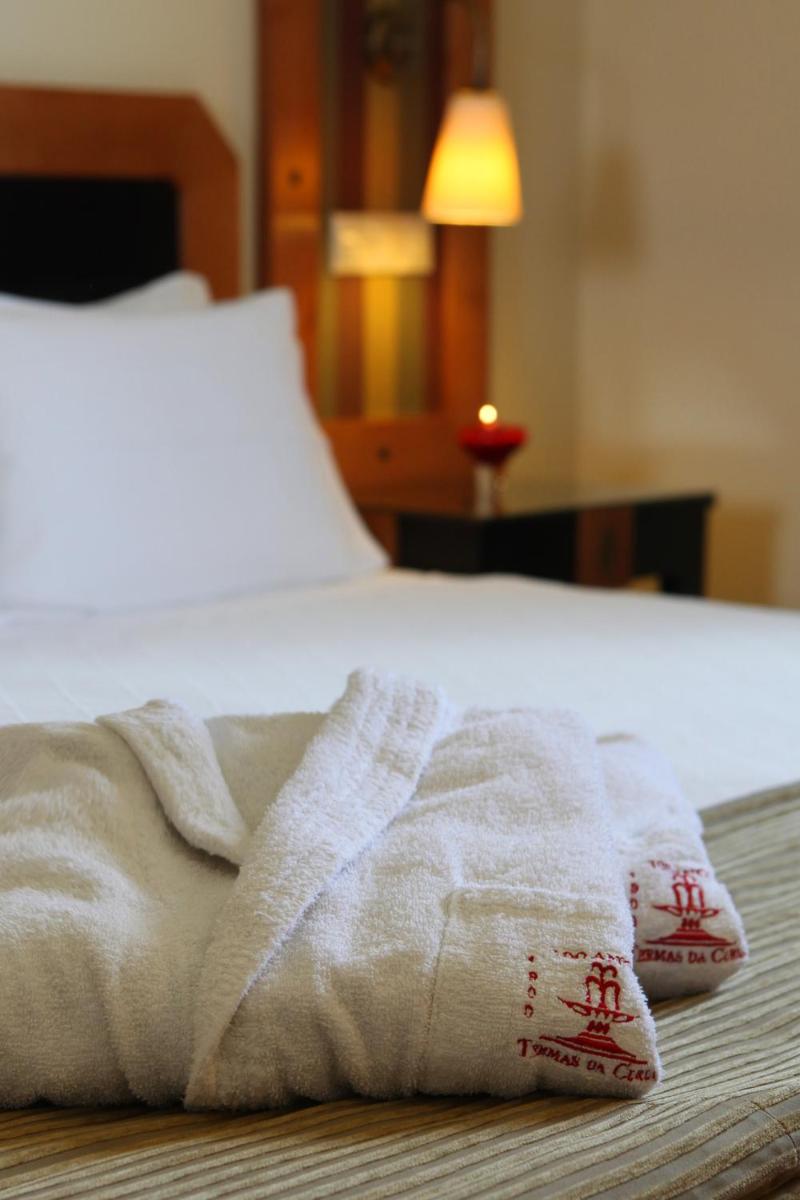 Uma cama ou camas num quarto em Hotel Termas da Curia