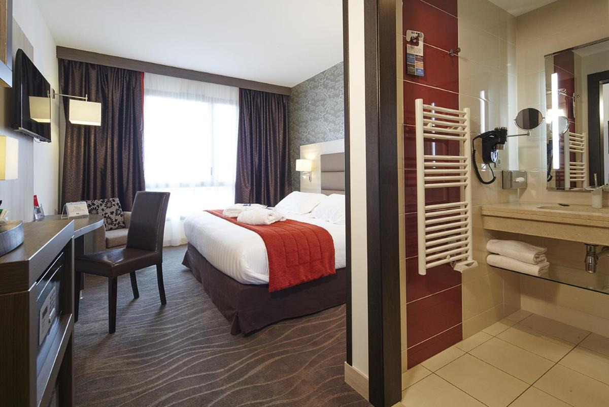 Un ou plusieurs lits dans un hébergement de l'établissement Kyriad Prestige Lyon Est - Saint Priest Eurexpo Hotel and SPA