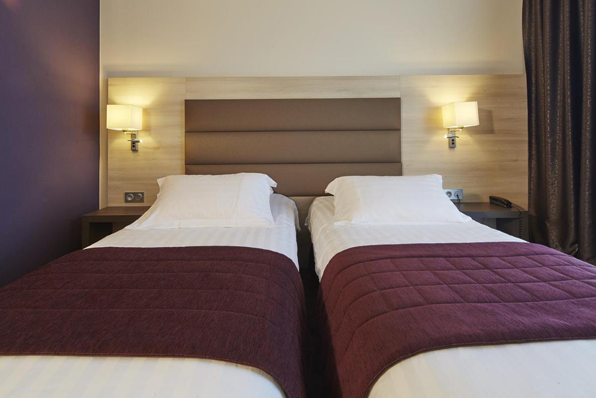 Un ou plusieurs lits dans un hébergement de l'établissement Kyriad Prestige Lyon Est - Saint Priest Eurexpo Hotel and SPA
