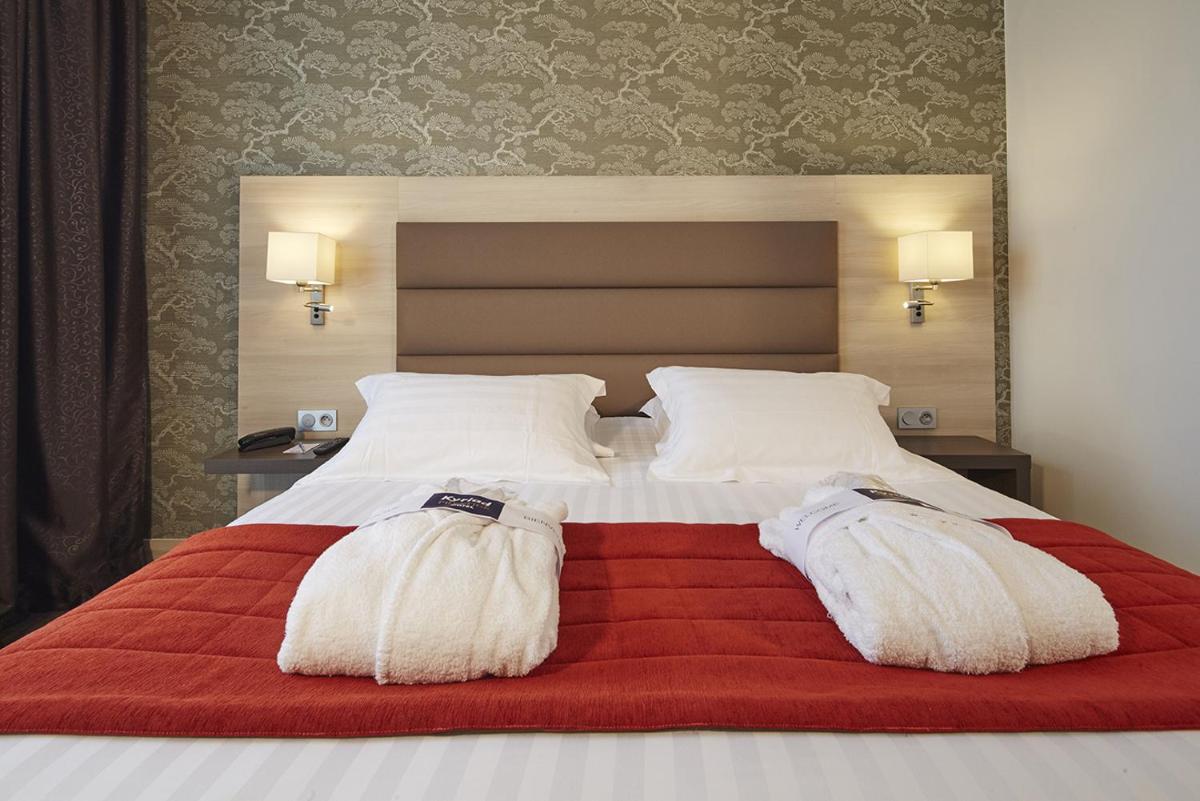 Un ou plusieurs lits dans un hébergement de l'établissement Kyriad Prestige Lyon Est - Saint Priest Eurexpo Hotel and SPA