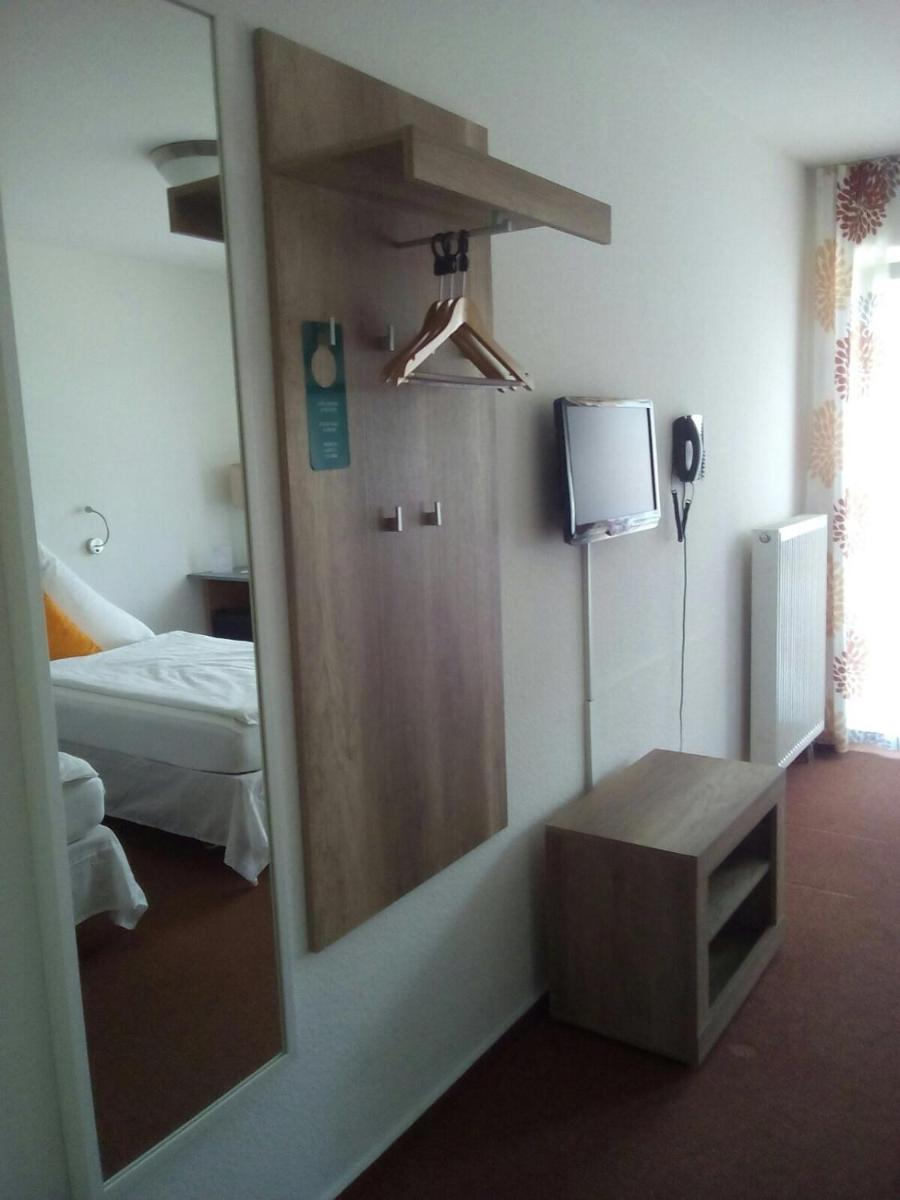 Ein Bett oder Betten in einem Zimmer der Unterkunft Hotel Astra Rastatt