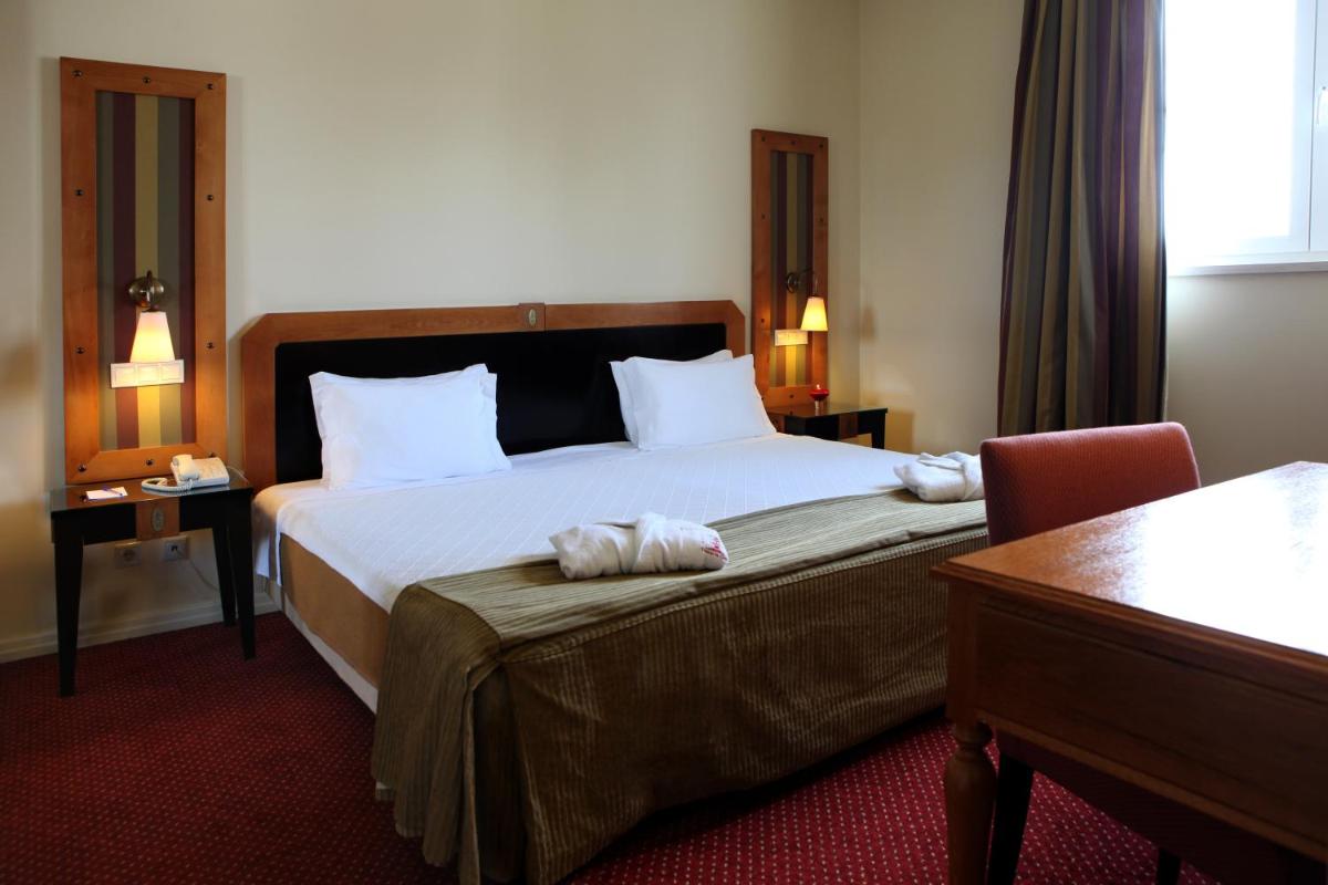 Uma cama ou camas num quarto em Hotel Termas da Curia