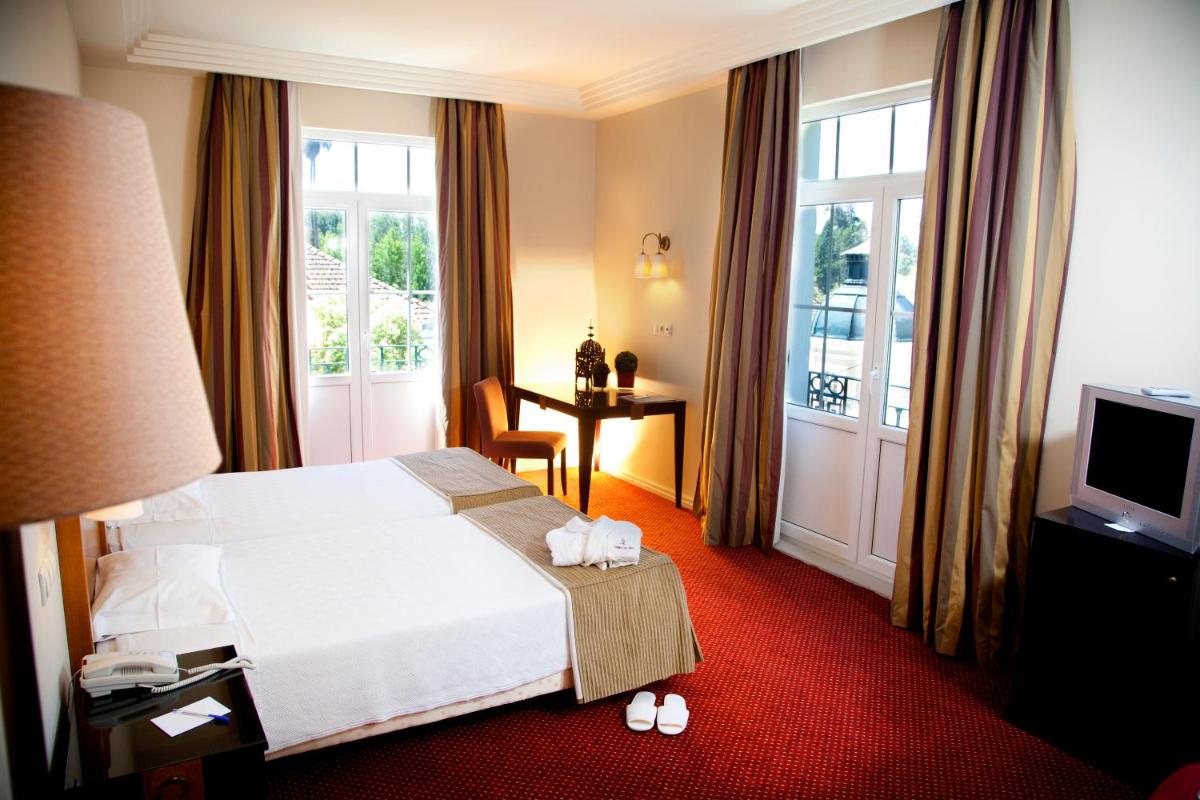 Uma cama ou camas num quarto em Hotel Termas da Curia