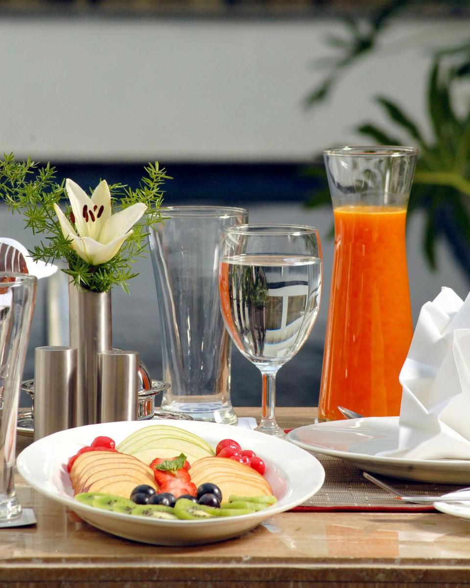 a table with a plate of food on a table at Fortune JP Palace, Mysore - Member ITC Hotels' Group in Mysore