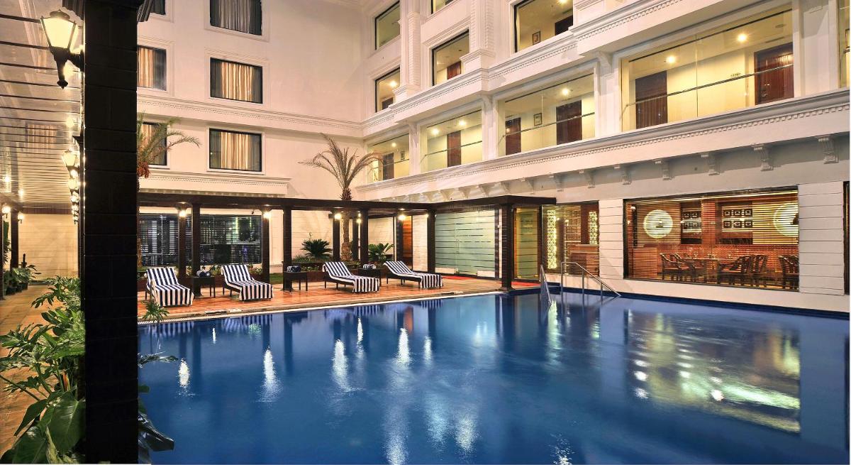 a swimming pool in the middle of a building at Fortune JP Palace, Mysore - Member ITC Hotels' Group in Mysore