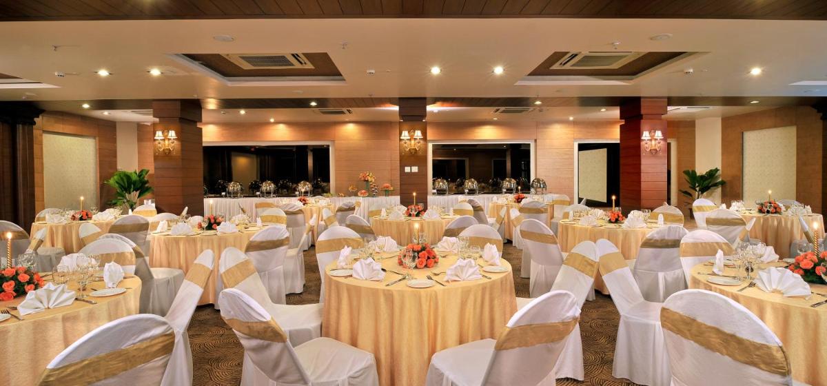 a banquet hall with tables and chairs in a room at Fortune JP Palace, Mysore - Member ITC Hotels' Group in Mysore