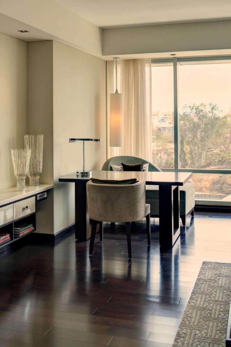 a dining room with a table and a chair at Park Hyatt Hotel and Residences, Hyderabad in Hyderabad