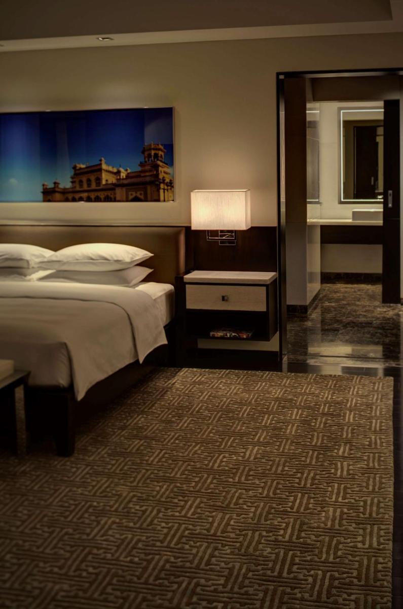 a hotel room with two beds and a carpet at Park Hyatt Hotel and Residences, Hyderabad in Hyderabad