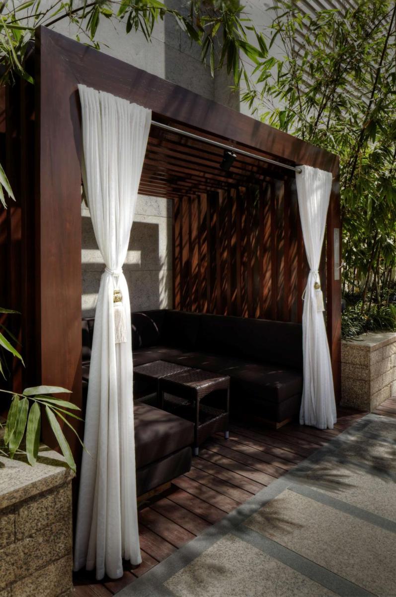 a living room with a couch and curtains at Park Hyatt Hotel and Residences, Hyderabad in Hyderabad