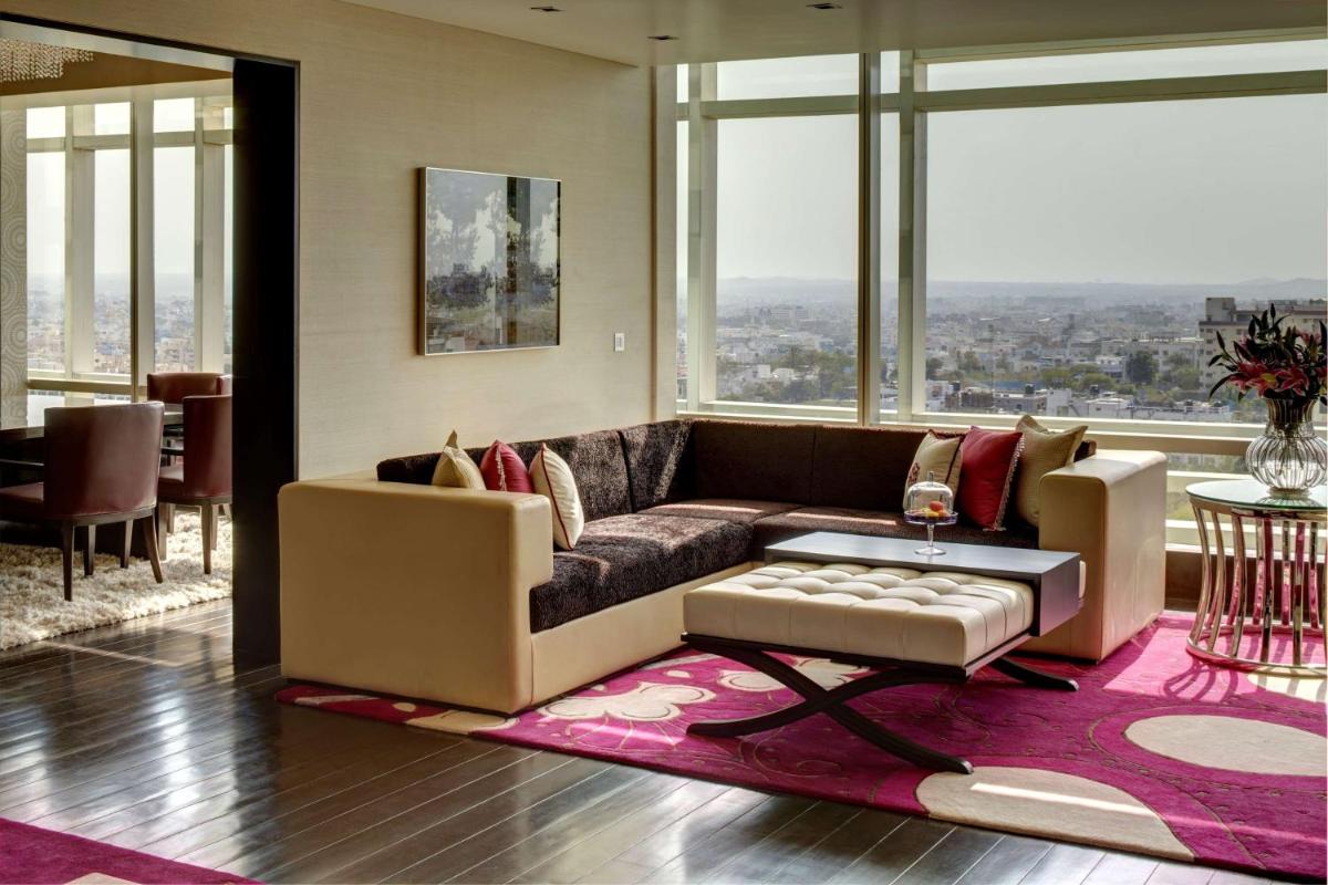 a living room with a couch and a table at Park Hyatt Hotel and Residences, Hyderabad in Hyderabad