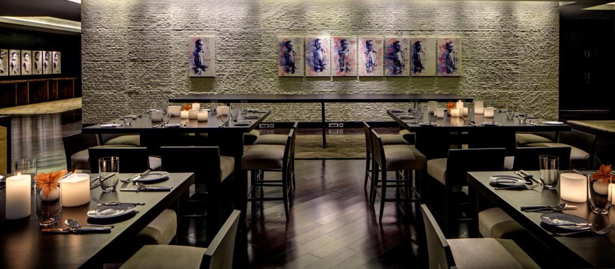 a restaurant with tables and chairs in a room at Park Hyatt Hotel and Residences, Hyderabad in Hyderabad