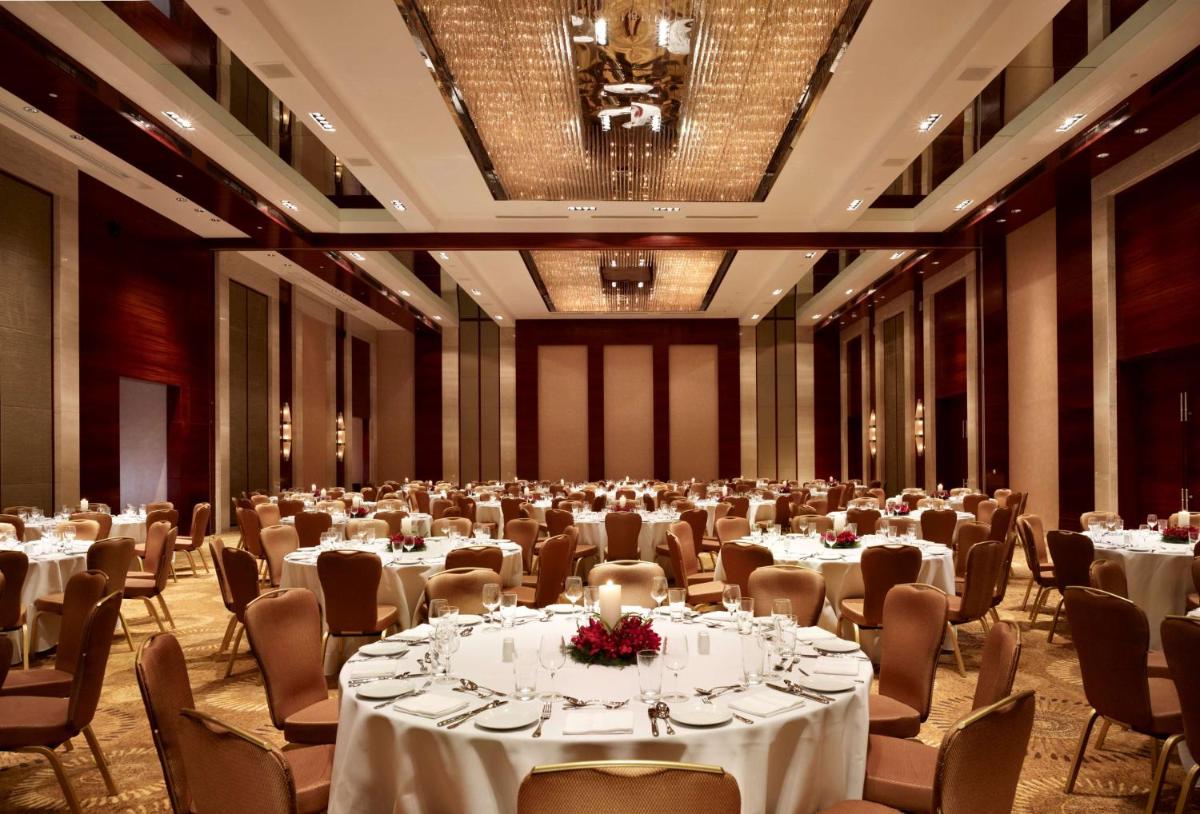 a large banquet hall with tables and chairs at Hyatt Regency Pune Hotel & Residences in Pune +106 photos