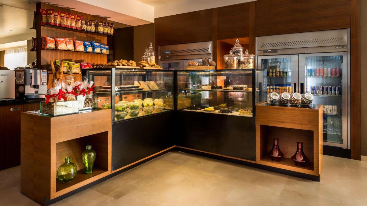 a display case in a store filled with lots of food at Hyatt Place Pune Hinjawadi in Pune