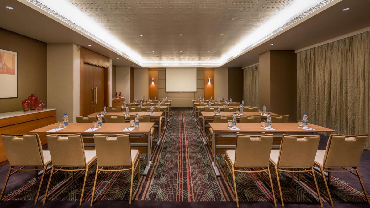 a conference room with rows of tables and chairs at Hyatt Place Pune Hinjawadi in Pune +47 photos
