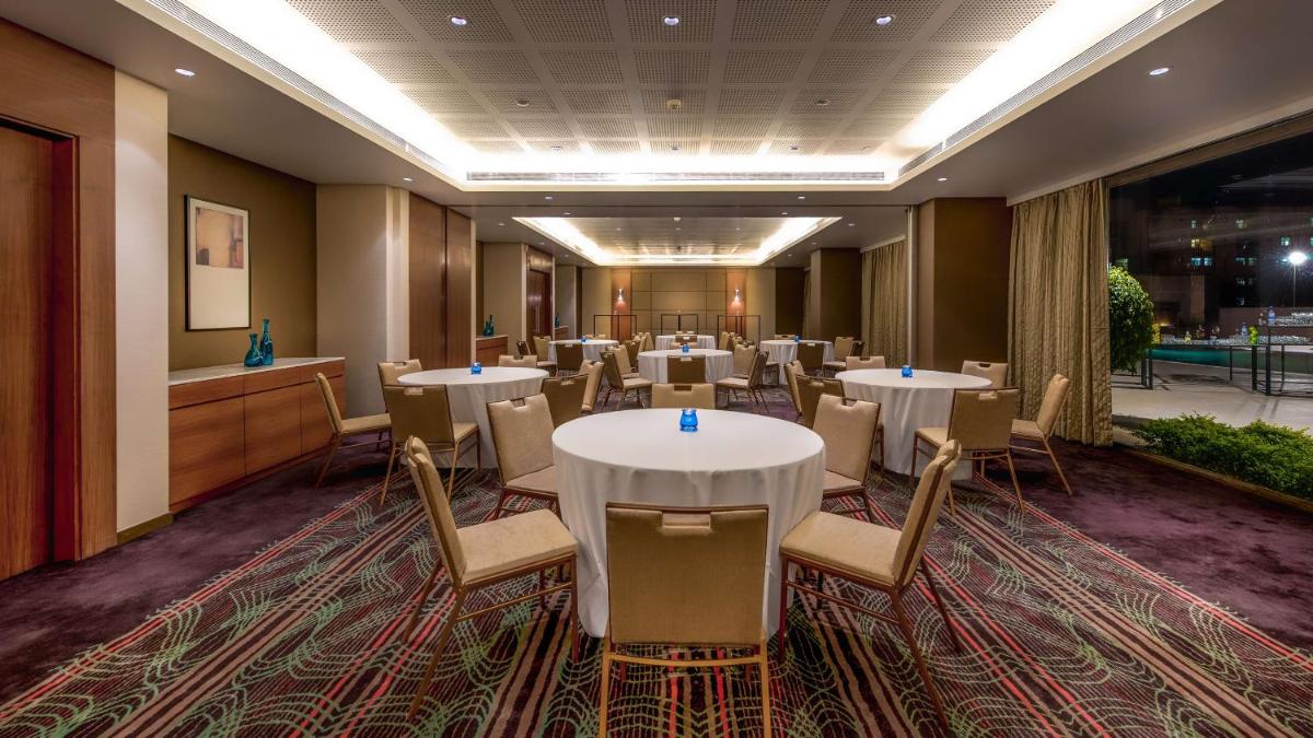 a conference room with tables and chairs in it at Hyatt Place Pune Hinjawadi in Pune