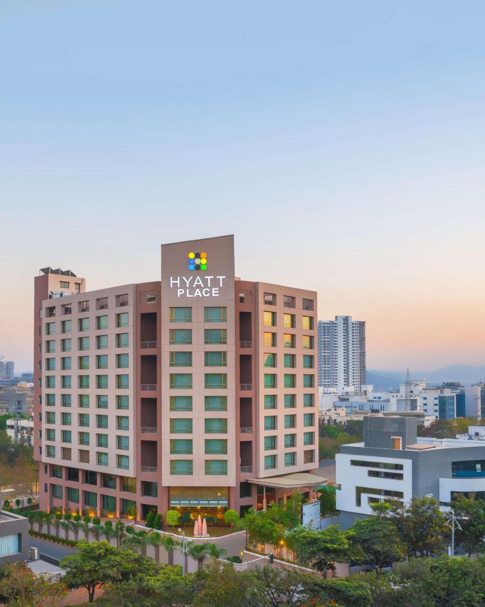 a hotel building with a klaw sign on top of it at Hyatt Place Pune Hinjawadi in Pune