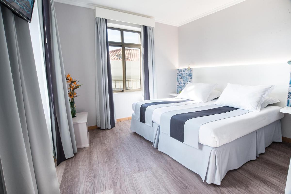 Uma cama ou camas num quarto em Sé Boutique Hotel