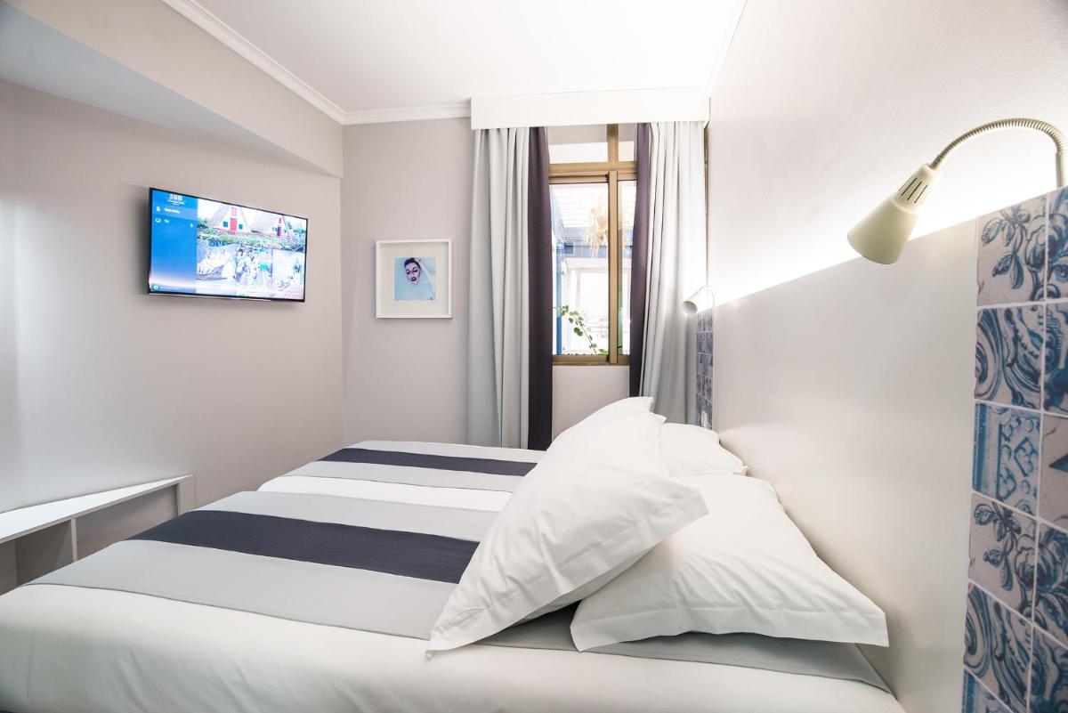Uma cama ou camas num quarto em Sé Boutique Hotel