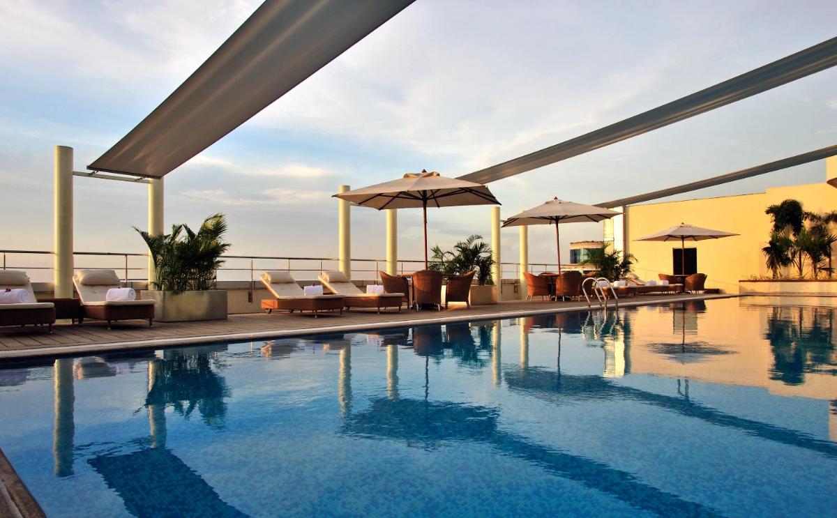 a swimming pool on the roof of a hotel at Taj Club House in Chennai