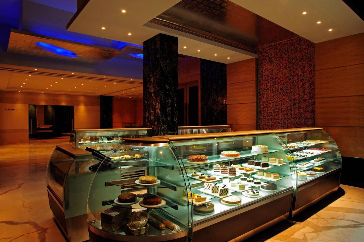 a display case filled with different types of food at Taj Club House in Chennai