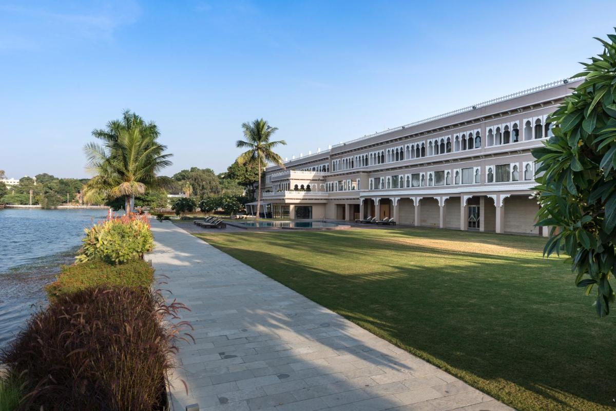a large building next to a body of water at Hotel Lakend in Udaipur