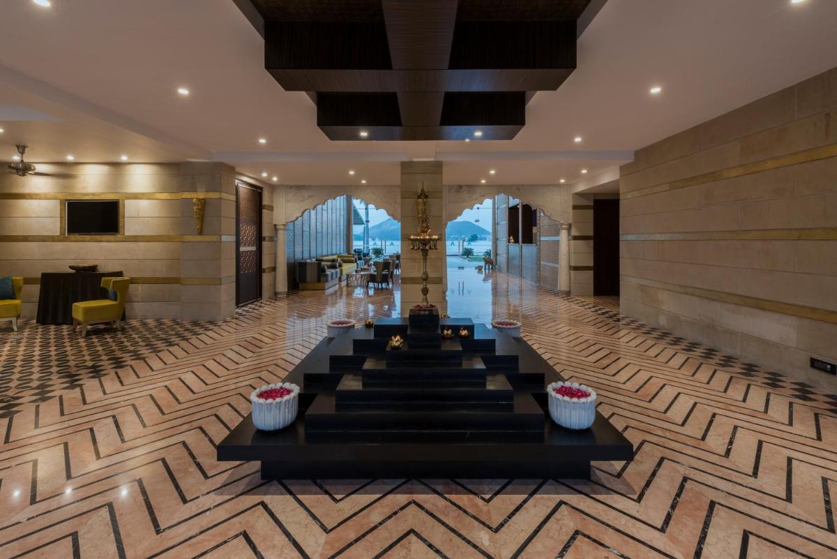 a lobby of a hotel with a table and chairs at Hotel Lakend in Udaipur