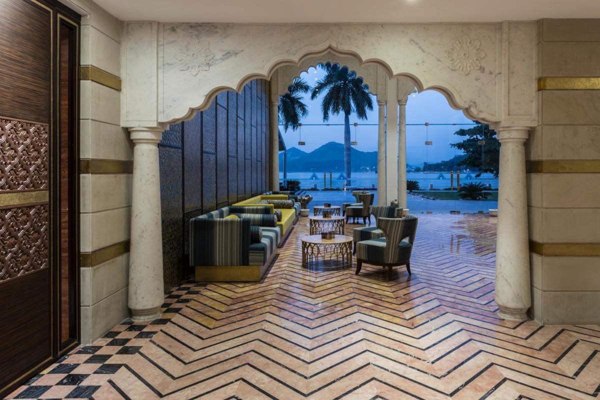 a lobby with chairs and tables in a building at Hotel Lakend in Udaipur