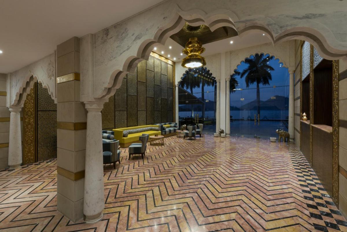 a lobby of a resort with a couch and chairs at Hotel Lakend in Udaipur