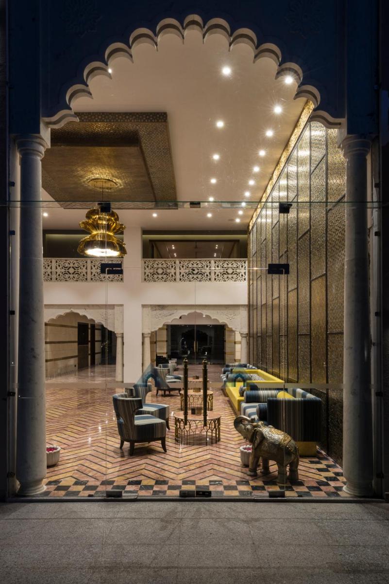 a lobby with couches and chairs in a building at Hotel Lakend in Udaipur