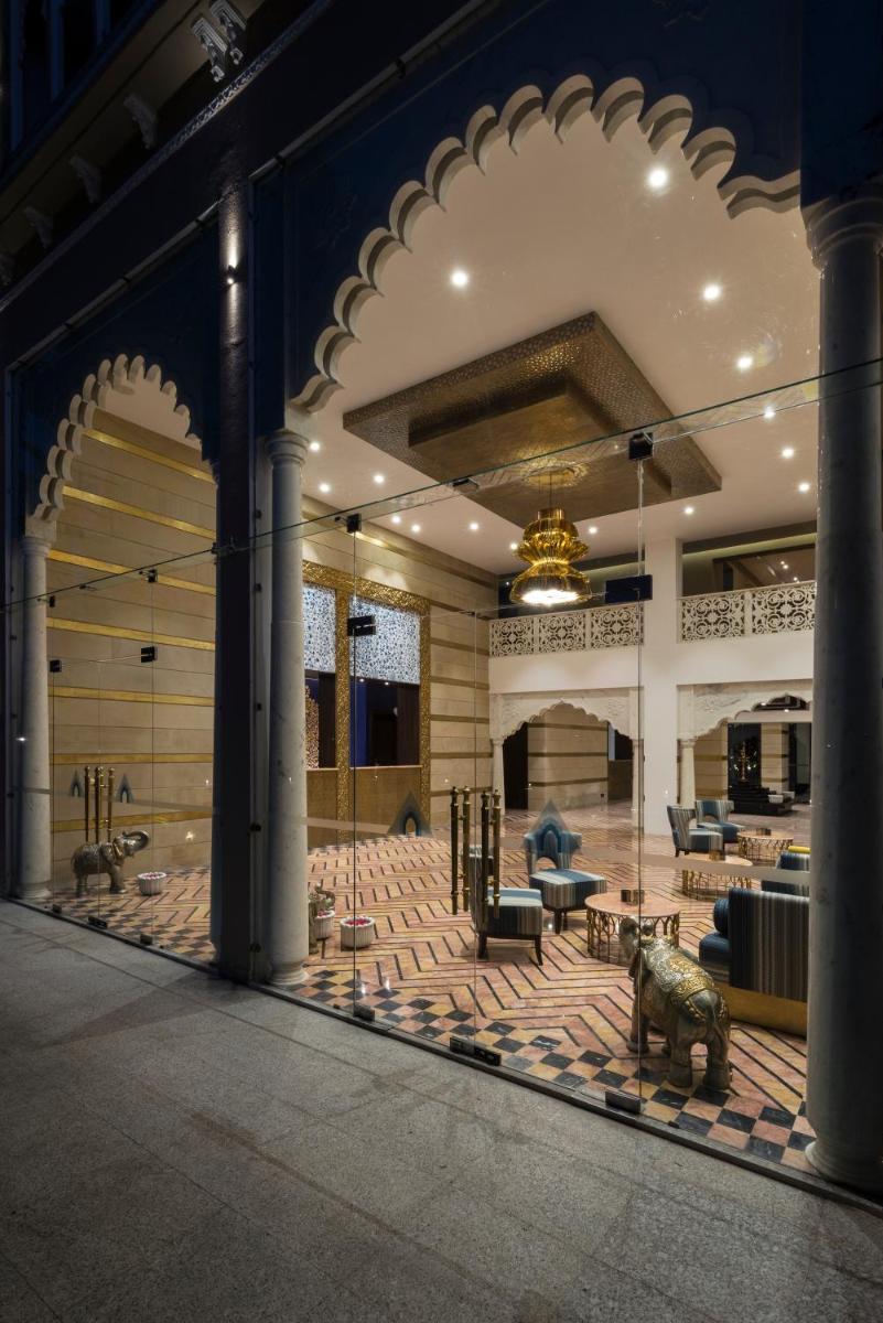 a large room with a lobby with tables and chairs at Hotel Lakend in Udaipur