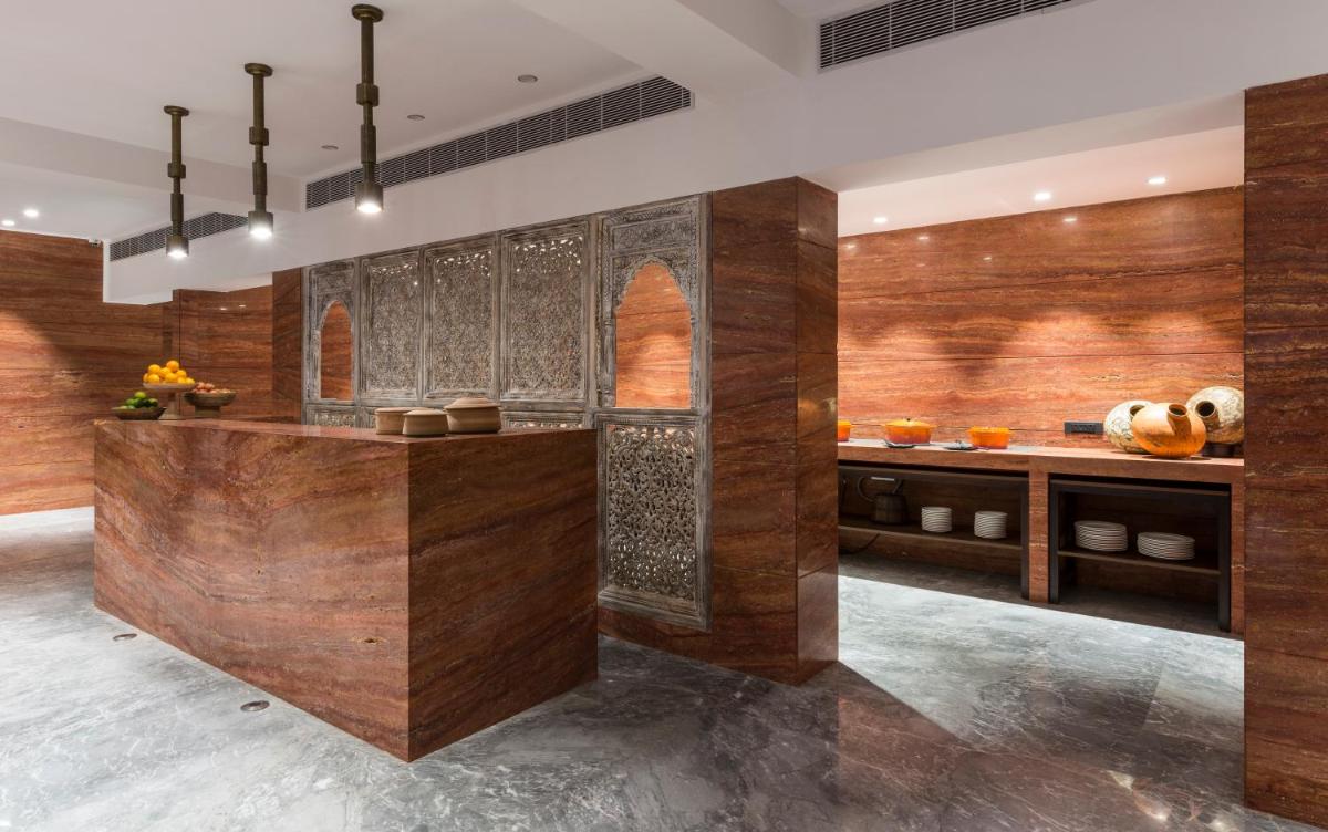 a kitchen with wooden walls and a counter at Hotel Lakend in Udaipur