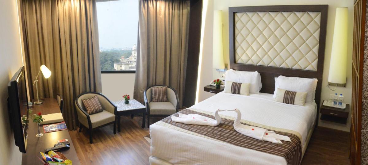 a hotel room with a bed and a window at Clarks Avadh in Lucknow