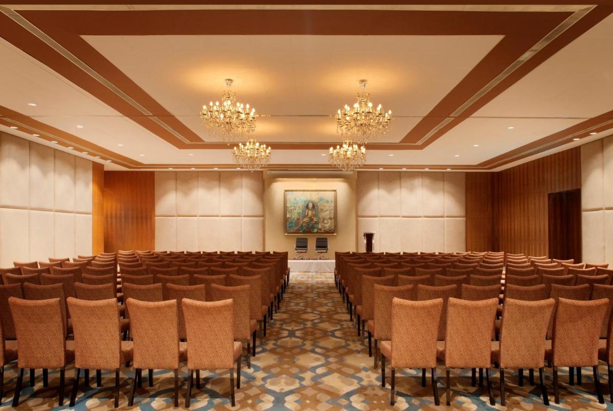 a conference room with rows of chairs and a painting at Radisson Blu Plaza Hotel Hyderabad Banjara Hills in Hyderabad +138 photos a conference room with rows of chairs and a painting at Radisson Blu Plaza Hotel Hyderabad Banjara Hills in Hyderabad +138 photos