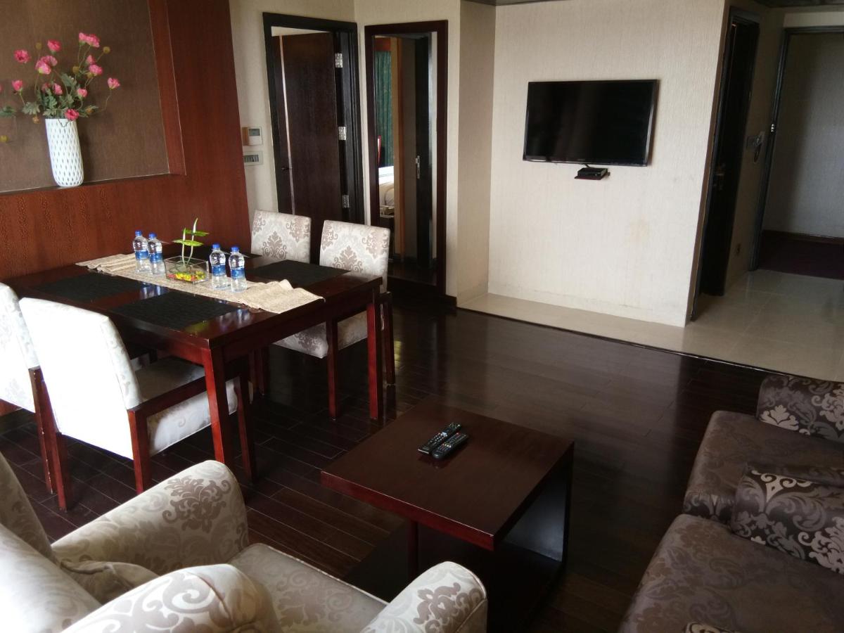 a living room with a table and a television at Fortune Select Grand Ridge, Tirupati - Member ITC Hotels' Group in Tirupati